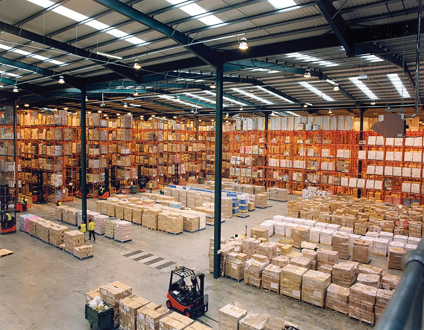 Pallet racking and packed cartons across a warehouse storage floor