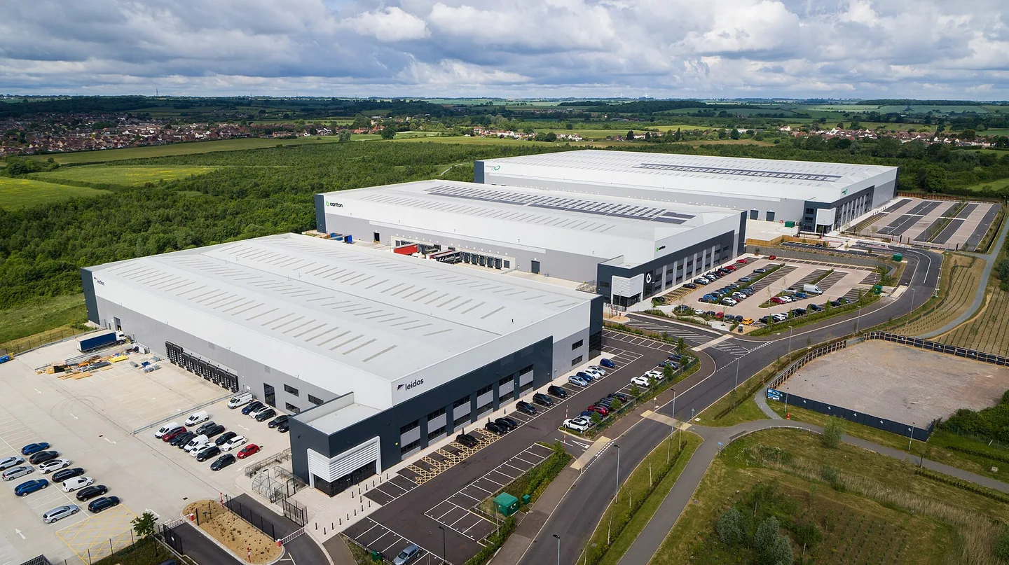 Aerial view of bright modern warehouse roofs and loading yards