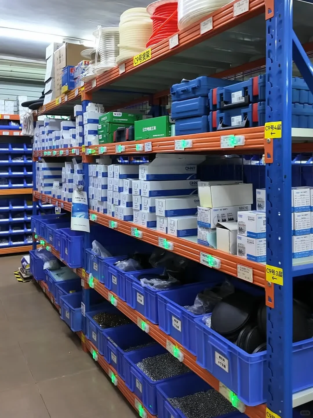 Rows of labelled parts bins in a warehouse picking aisle