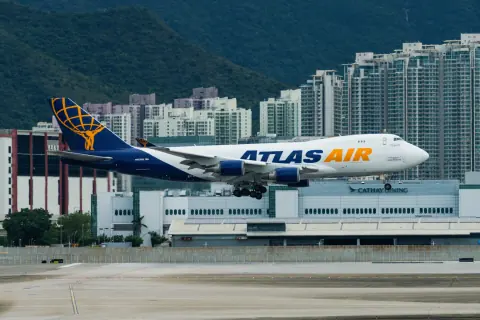 Atlas Air cargo aircraft on an airport taxiway with buildings behind