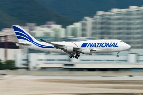 National cargo aircraft taxiing in front of city buildings