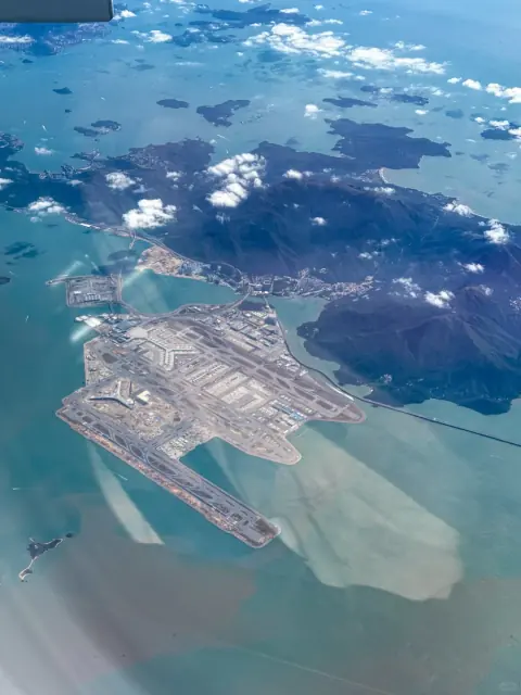 Coastal airport and reclaimed land seen from high above