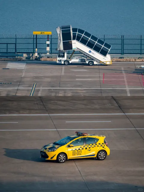 Paired views of a boarding stairway and airport escort vehicle