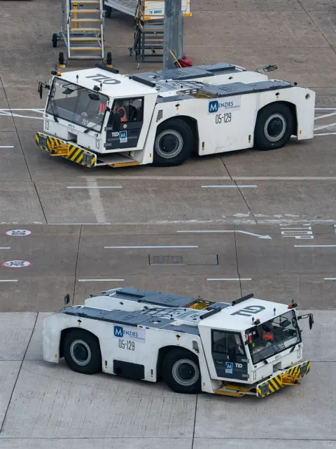 Paired views of aircraft pushback tractors on the airport apron