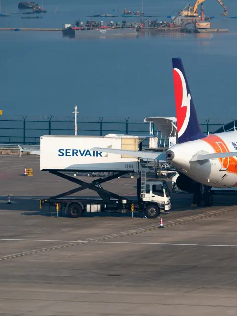 Aircraft cargo loading platform beside a parked aircraft on the apron