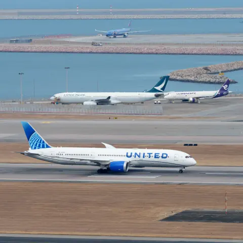 Aircraft at different distances on parallel coastal airport taxiways