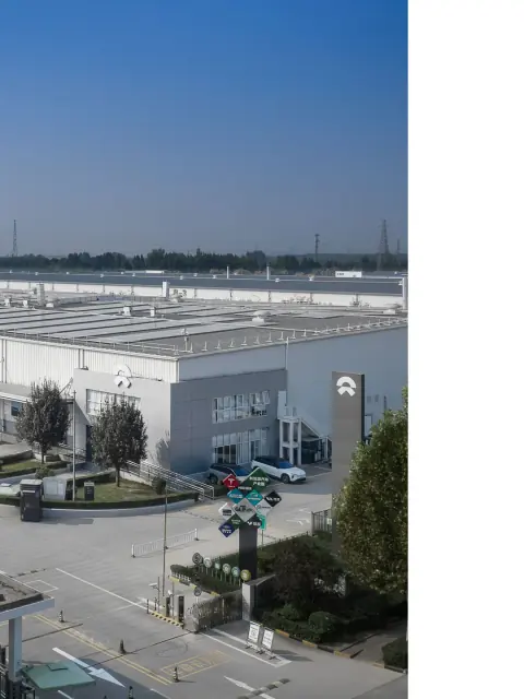 Grey warehouse corner and vehicle access road in a logistics park