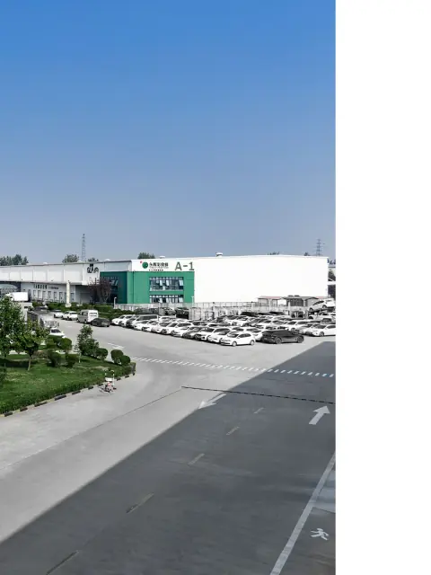 Wide logistics park roadway beside a warehouse loading frontage