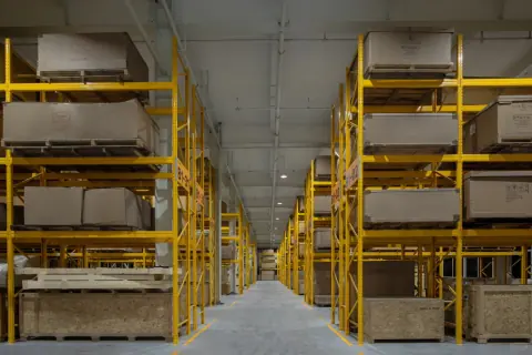 Symmetrical storage aisle between yellow warehouse racks