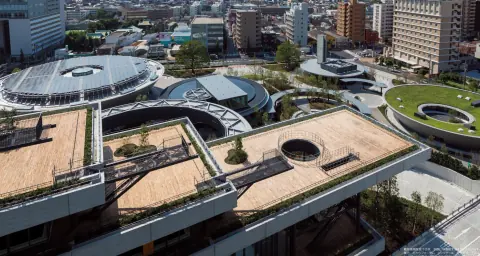 Rooftop circulation routes, planting and circular structures at a logistics complex