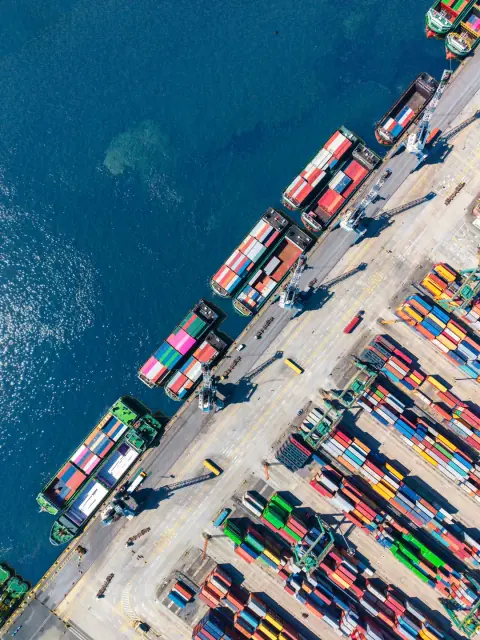 Diagonal container quay with ships and blue water seen from above