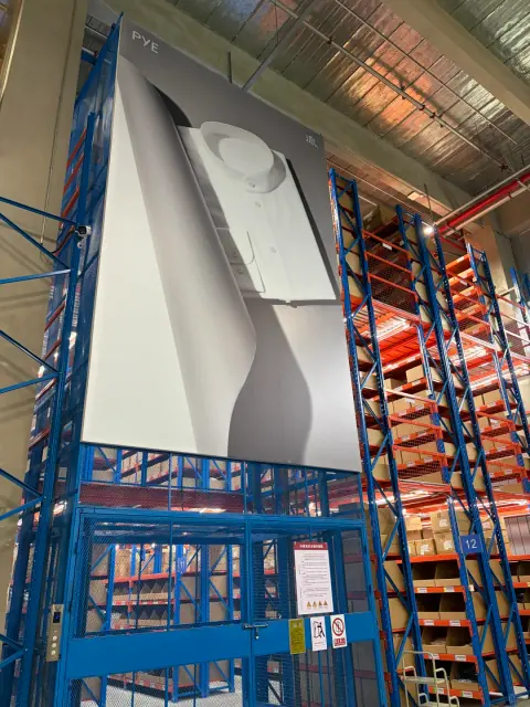 Overhead handling equipment above warehouse storage aisles