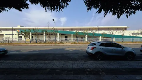 Low distribution building and roadside landscaping at dusk