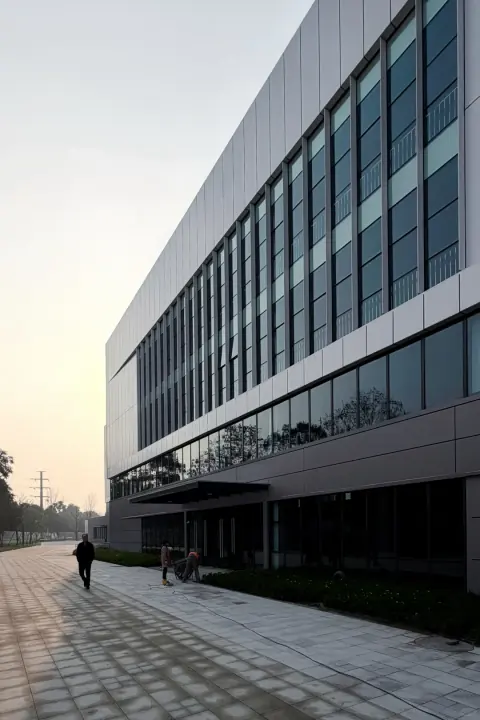 Long glazed facade and covered loading area of a distribution building