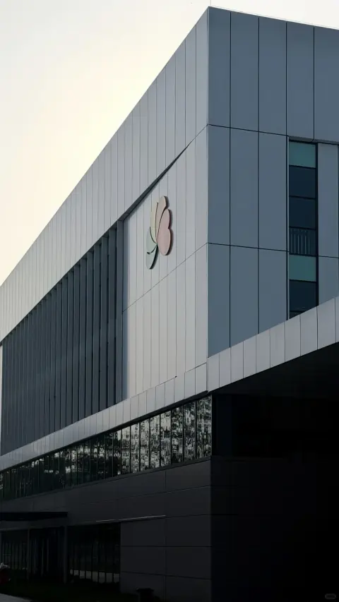 Angular white distribution building beneath a clear sky