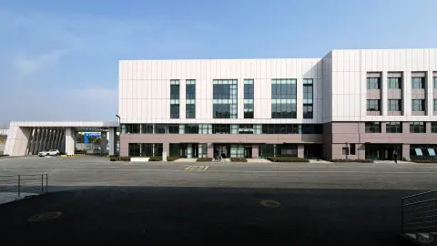 Wide distribution centre frontage with windows and covered loading bays