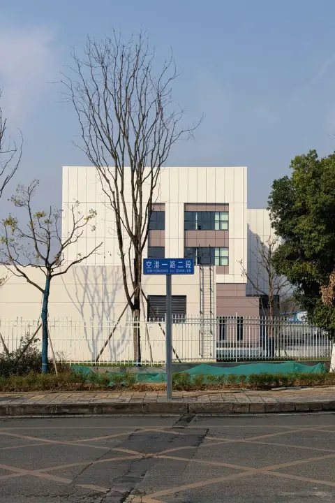 Distribution centre building framed by trees and a courtyard