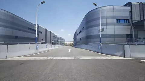 Curving vehicle ramp around a modern warehouse building