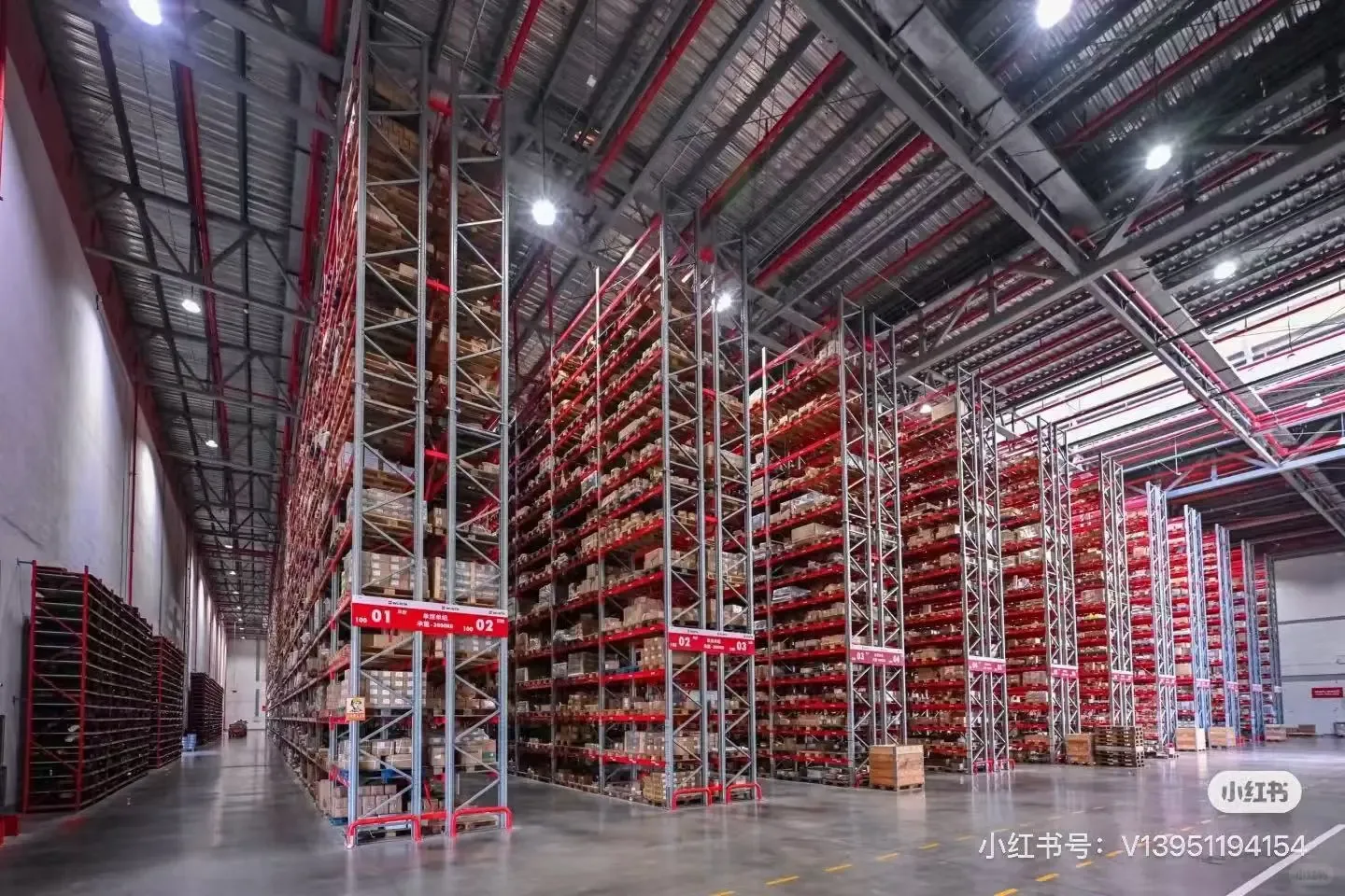Large automated warehouse with tall red steel storage structures