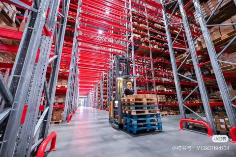 Red high-bay storage racks and a clear warehouse floor