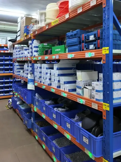 Rows of labelled parts bins in a warehouse picking aisle