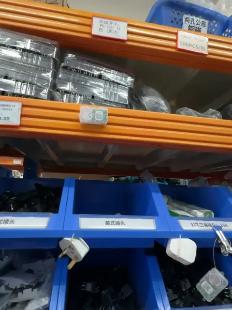 Orange rack beam and blue bins used for warehouse parts storage
