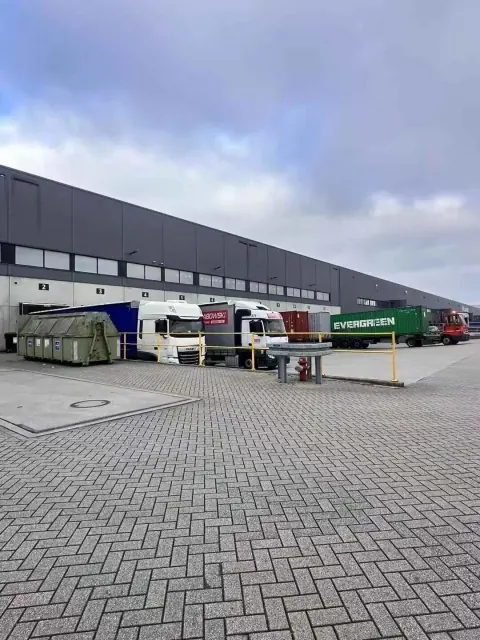 Warehouse loading yard with parked trailers and service doors