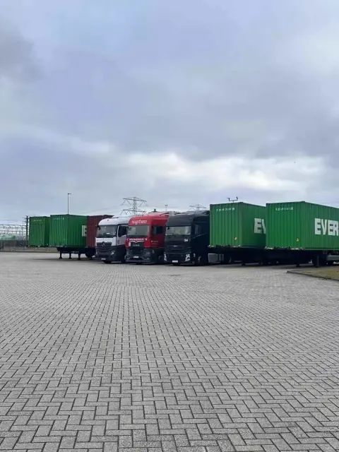 Truck trailers beside a long warehouse loading area